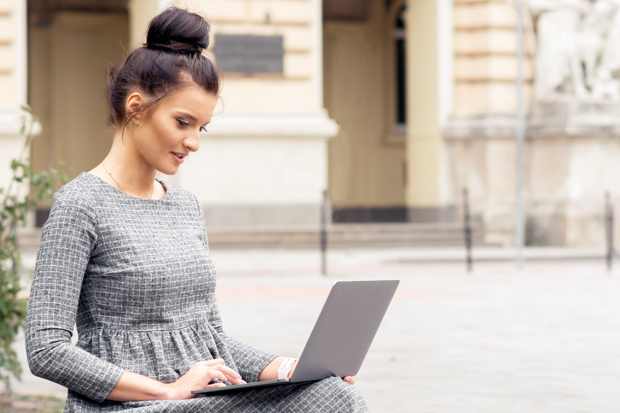 Student Adult Girl Is Working On Laptop Computer Near Building O