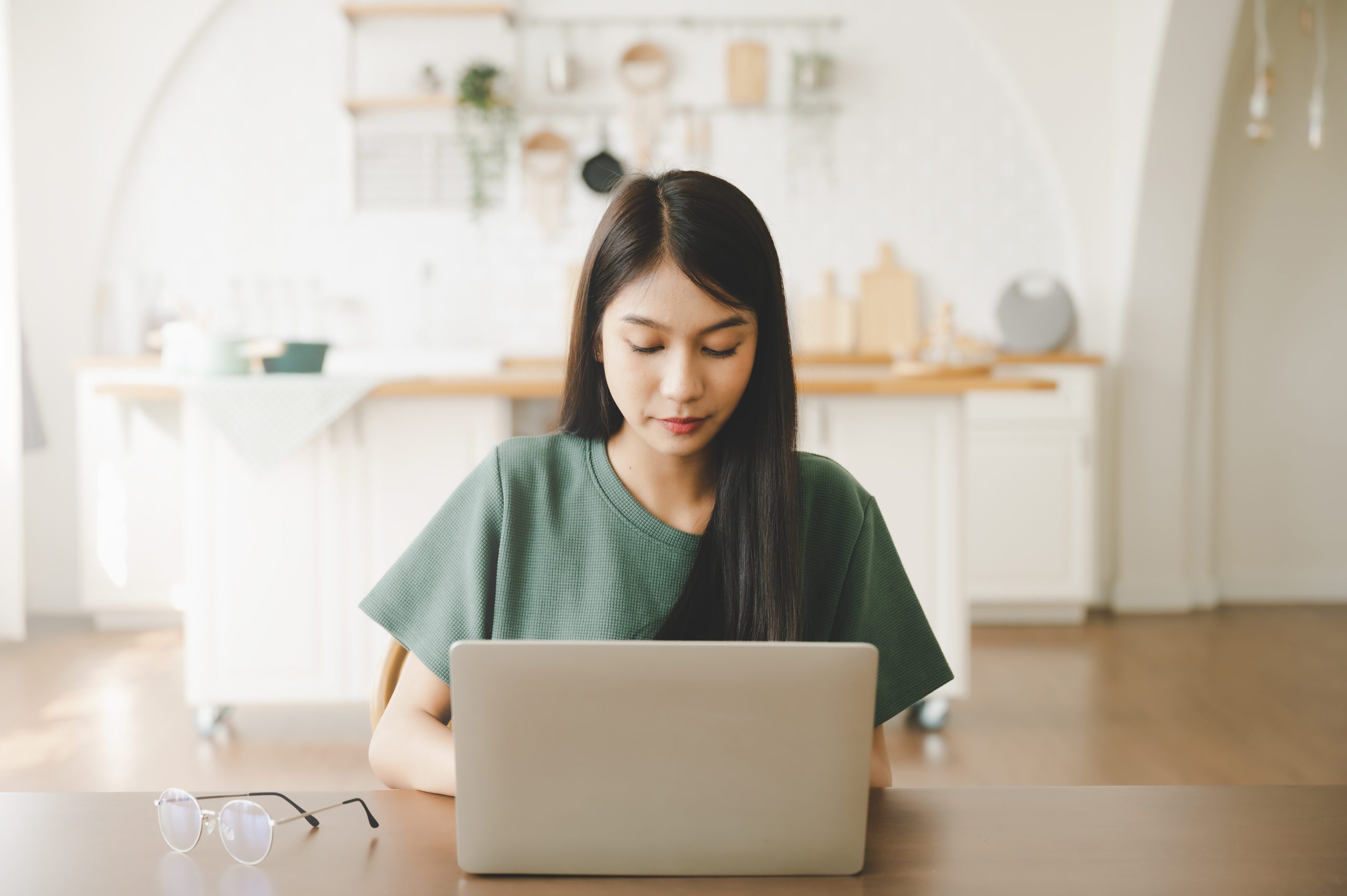 Smiling Asian Young Woman Working On Laptop At Home Office. Youn
